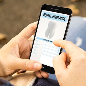 Patient looking at dental insurance form on phone