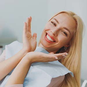 Woman smiling while sitting in treatment chair