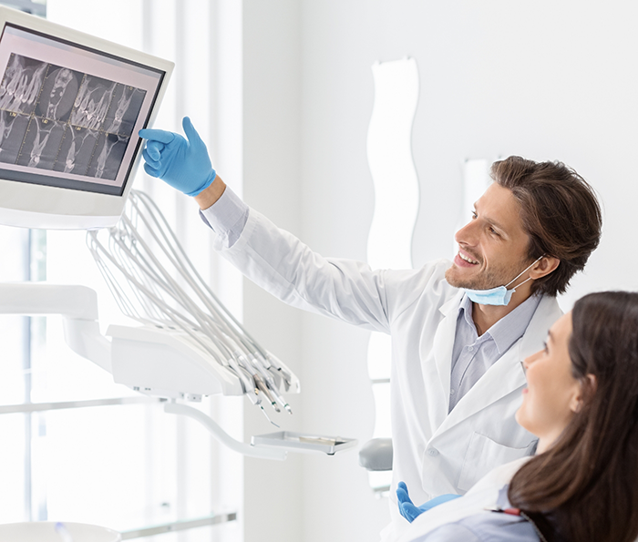 Dentist showing a patient x rays of their teeth