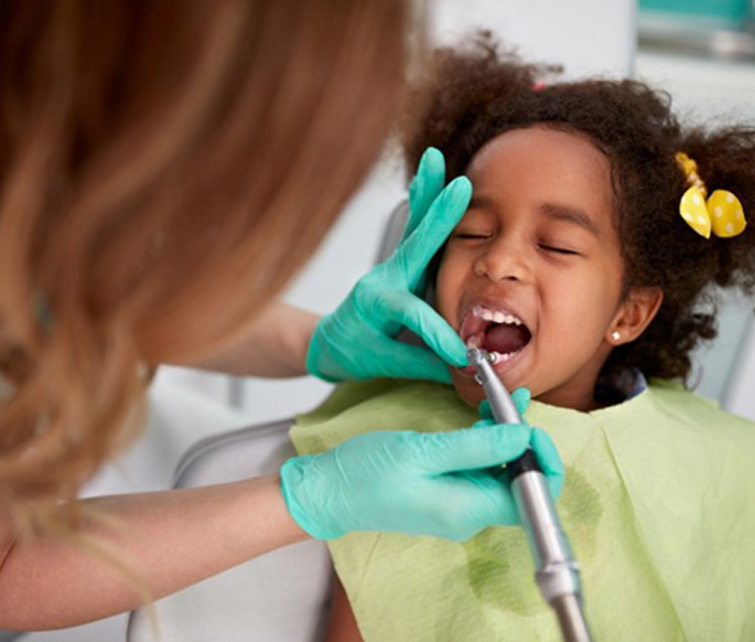 Little girl having her teeth cleaned