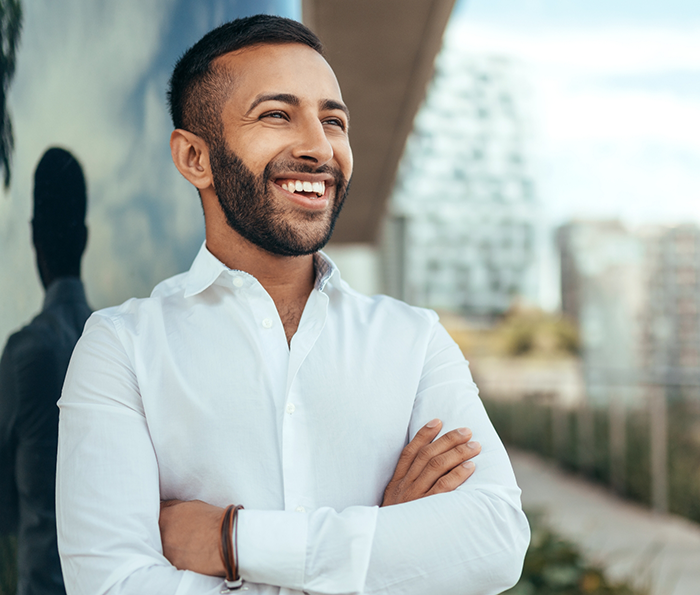 Man smiling and crossing his arms