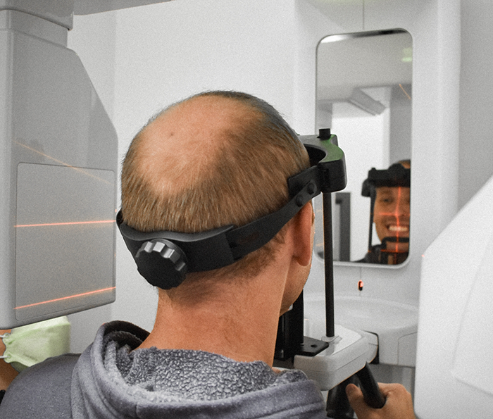 Dental patient getting a C T cone beam scan of his mouth and jaws