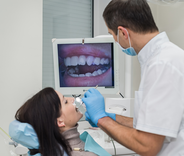 Dentist taking close up images of a patients teeth