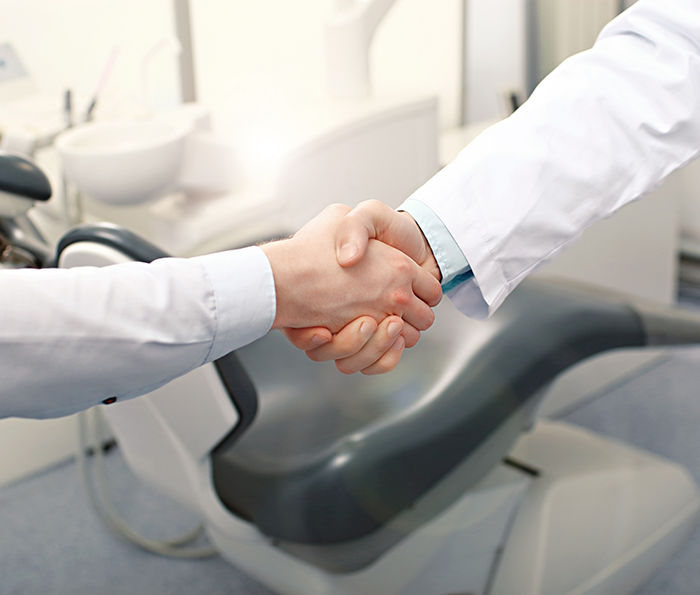 Patient shaking hands with their dentist