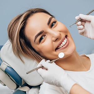 Woman in white t-shirt about to undergo dental exam