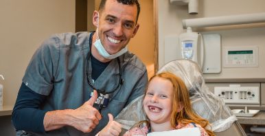 Salmon Creek dentist and a young girl in dental chair giving thumbs up