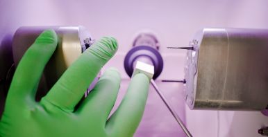 Dentist placing ceramic block into same day dental crown machine