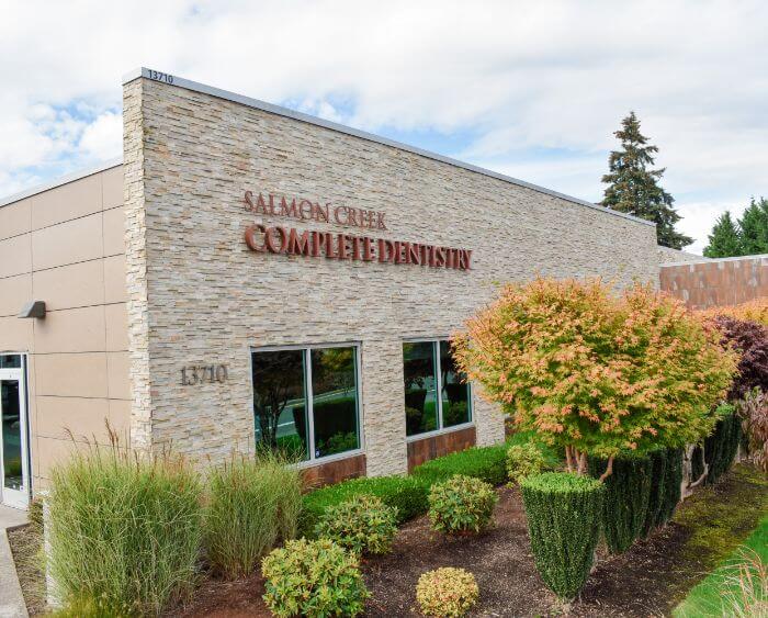 Small garden with bushes in front of Salmon Creek Complete Dentistry