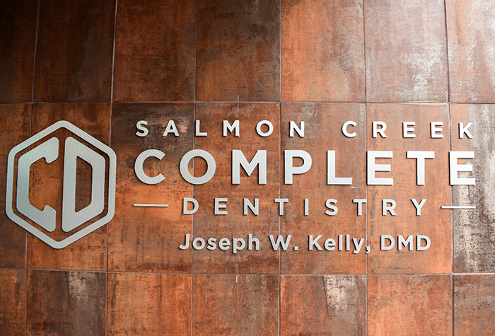 Plaque on wall reading Salmon Creek Complete Dentistry Joseph W Kelly D M D