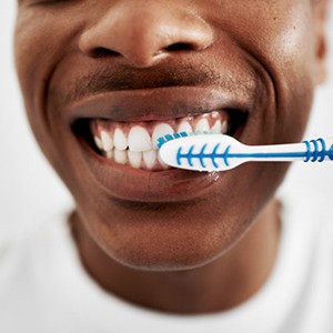 a man brushing his teeth at home