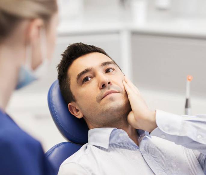 Concerned patient speaking with dental team member