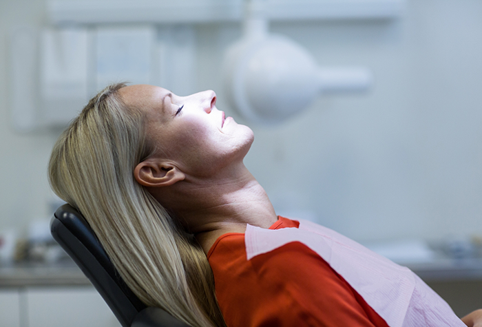 Woman relaxing in dental chair thanks to sedation dentistry in Salmon Creek