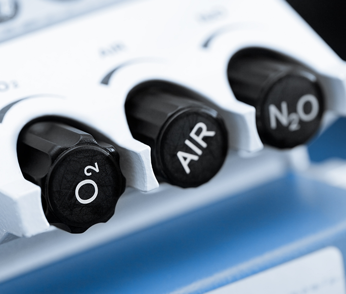 Buttons on a machine labeled oxygen air and nitrous oxide