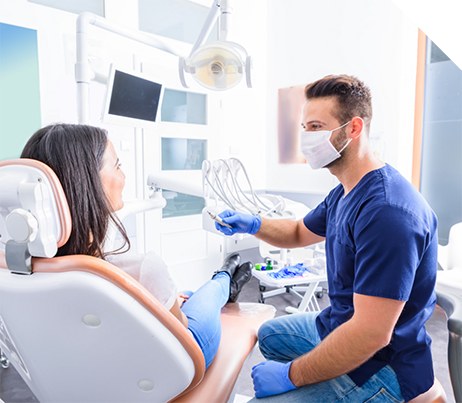 Dentist talking to a patient in the dental chair