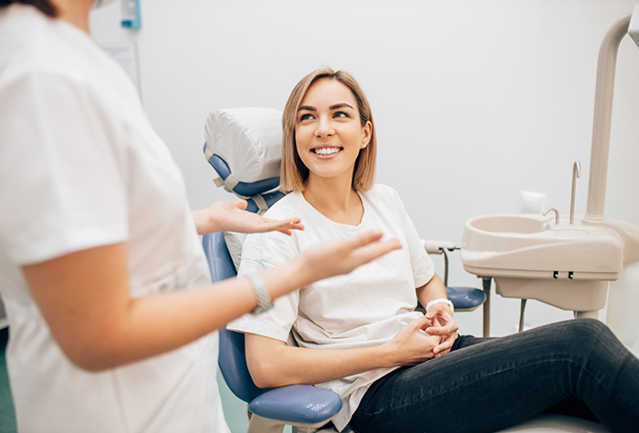 Woman listening to her dentist talk about wisdom tooth extractions in Salmon Creek